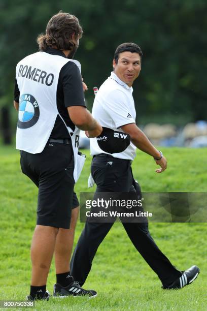 Andres Romero of Argentina walks off the 18th green with his caddie during the final round of the BMW International Open at Golfclub Munchen...