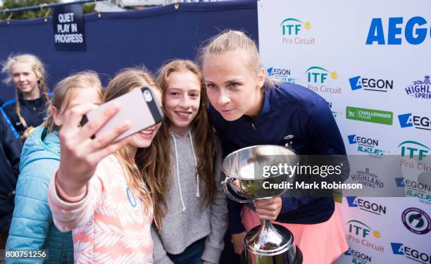 Magdalena Rybarikova of Russia with her winners trophy and some fans after the womens's singles final on June 25, 2017 in Ilkley, England.