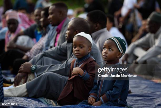 Young boys wait for the beginning of a prayer during an Eid al-Fitr celebration, which marks the end of Ramadan, on June 25, 2017 in Pittsburgh,...
