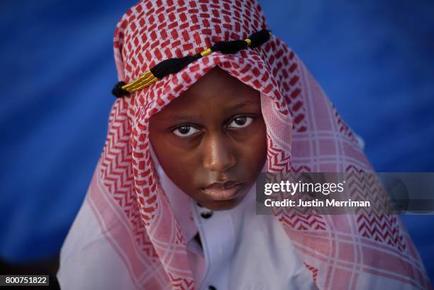 Hamadi Hamadi of Pittsburgh's North Side, waits for the prayer to begin during an Eid al-Fitr celebration, marking the end of Ramadan, on June 25,...