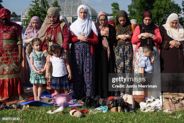 Women stand in prayer during an Eid al-Fitr celebration, marking the end of Ramadan, on June 25, 2017 in Pittsburgh, Pennsylvania. The celebration...