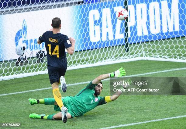 Australia's forward James Troisi scores the first goal in the nets of Chile's goalkeeper Claudio Bravo during the 2017 Confederations Cup group B...
