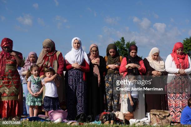 Women stand in prayer during an Eid al-Fitr celebration, marking the end of Ramadan, on June 25, 2017 in Pittsburgh, Pennsylvania. The celebration...