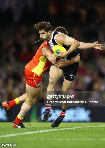 Koby Stevens of the Saints is tackled during the round 14 AFL match between the St Kilda Saints and the Gold Coast Suns at Etihad Stadium on June 25,...