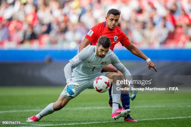 Alexis Sanchez of Chile chases the ball from Maty Ryan of Australia during the FIFA Confederations Cup Russia 2017 group B football match between...