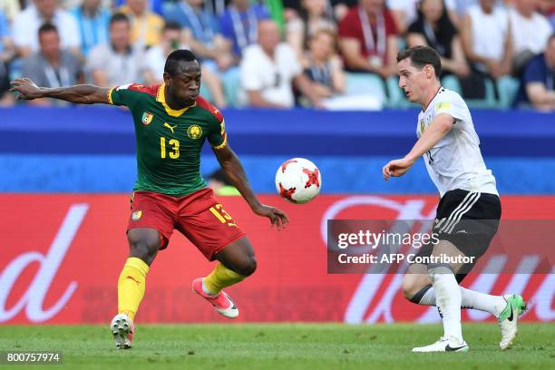 Germany's midfielder Sebastian Rudy challenges Cameroon's forward Christian Bassogog during the 2017 FIFA Confederations Cup group B football match...