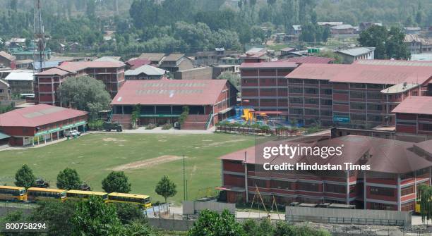 Army vehicles stationed inside the Delhi Public School during a gunfignt with militants and forces at Pantha Chowk on the outskirts of Srinagar, on...