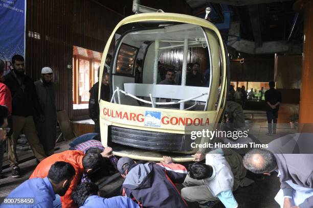 Officials check the damaged Gondola in which the tourists were travelling, on June 25, 2017 in Srinagar, India. A family from Delhi and a local...