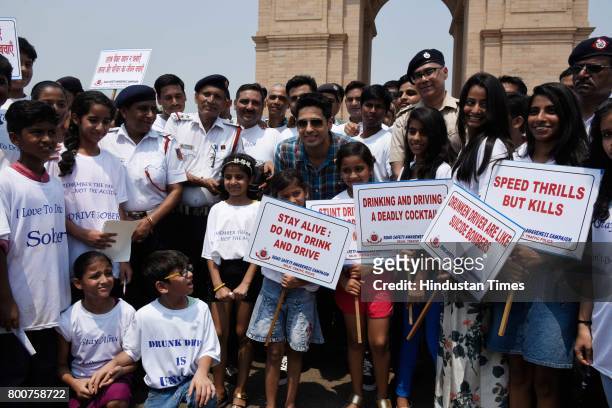 Bollywood actor Siddharth Malhotra along with school children participates during a Delhi road safety activity to spread awareness on anti-drunken...
