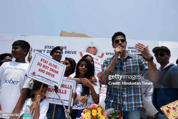 Bollywood actor Siddharth Malhotra along with school children participates during a Delhi road safety activity to spread awareness on anti-drunken...