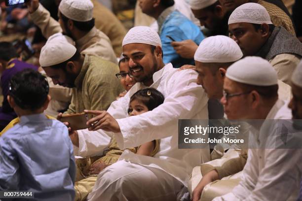 Muslims take selfies before a prayer service celebrating Eid-al-Fitr on June 25, 2017 in Stamford, Connecticut. The Islamic holiday celebrates the...
