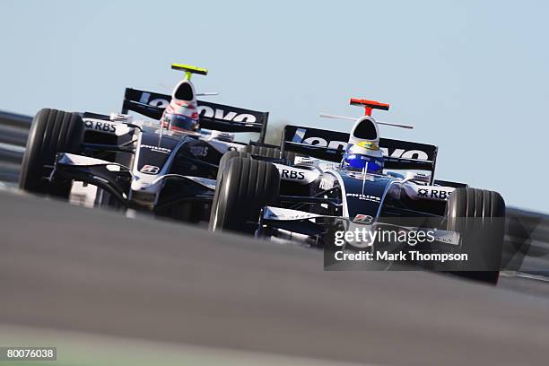 Kazuki Nakajima of Japan and Williams and Nico Rosberg of Germany and Williams in action during pre-season Formula One winter testing at the...