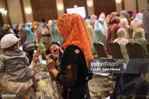 Newborn cries during a prayer service celebrating Eid-al-Fitr on June 25, 2017 in Stamford, Connecticut. The Islamic holiday celebrates the end of...