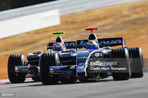 Kazuki Nakajima of Japan and Williams and Nico Rosberg of Germany and Williams in action during pre-season Formula One winter testing at the...