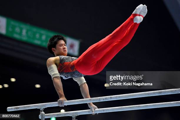 Kenya Yuasa competes in the Parallel Barsduring Japan National Gymnastics Apparatus Championships at the Takasaki Arena on June 25, 2017 in Takasaki,...