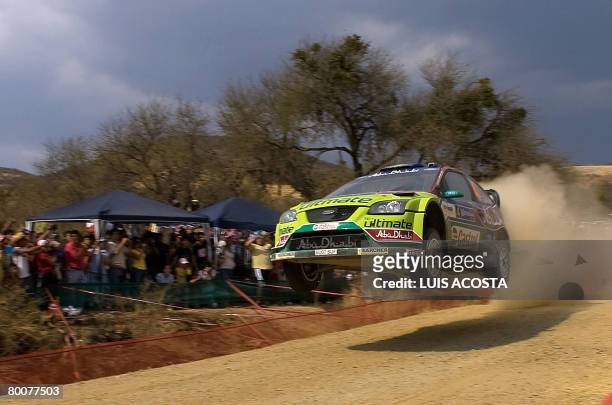 Finnish Jari-matti Latvala jumps with his Ford Focus during the second day of the FIA World Rally Championship's in Leon, Mexico, on March 1, 2008....