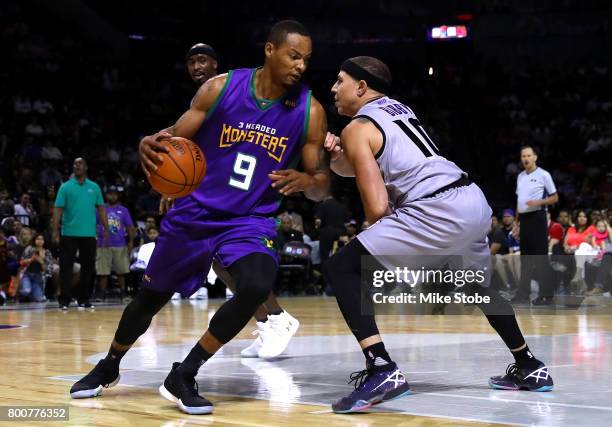 Rashard Lewis of the 3 Headed Monsters handles the ball against Mike Bibby of the Ghos Ballers during week one of the BIG3 three on three basketball...