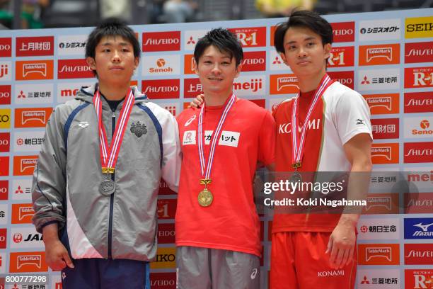 Silver Medalist Hidetaka Miyaji, Gold medalist Kohei Uchimura and Bronze medalist Yusuke Tanaka pose for photographs in the award ceremony for the...