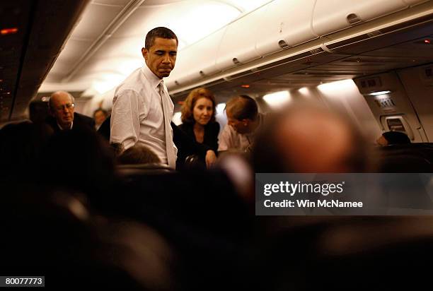 Democratic presidential candidate Sen. Barack Obama speaks to members of the press on board his campaign plane March 1, 2008 before landing in...