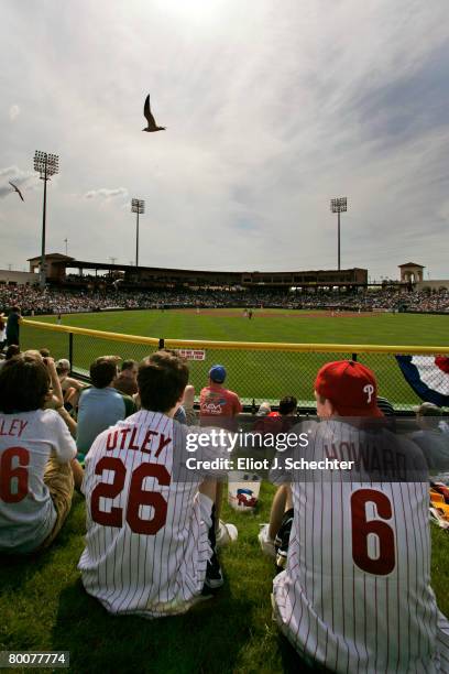 Philadelphia Phillies fans sit in the outfield while watching their team play the New York Yankees during a Spring Training game at Bright House...