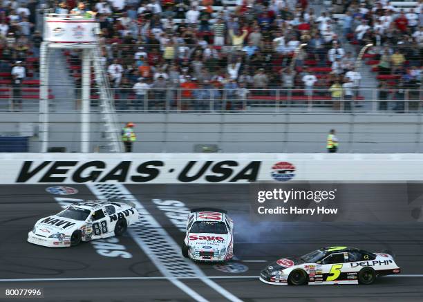 Brad Keselowski, driver of the U.S. NAVY Chevrolet, and Carl Edwards, driver of the Save a lot Ford, spin out of control after a incident caused by...