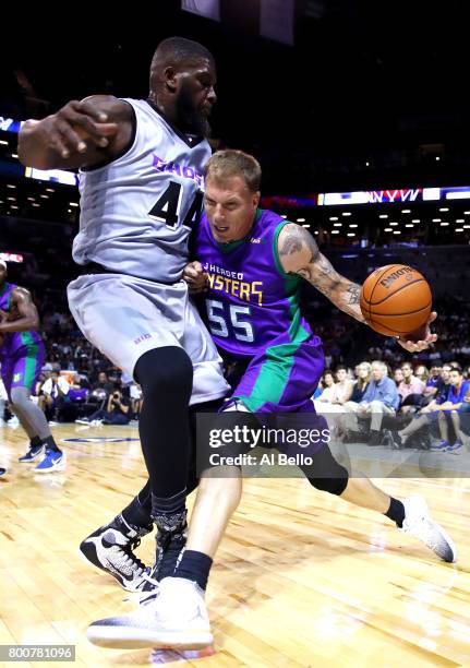 Jason Williams of the 3 Headed Monsters drives to the basket against Ivan Johnson of the Ghost Ballers during week one of the BIG3 three on three...