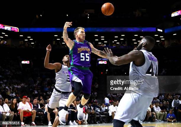 Jason Williams of the 3 Headed Monsters passes against Ivan johnson of the Ghost Ballers during week one of the BIG3 three on three basketball league...