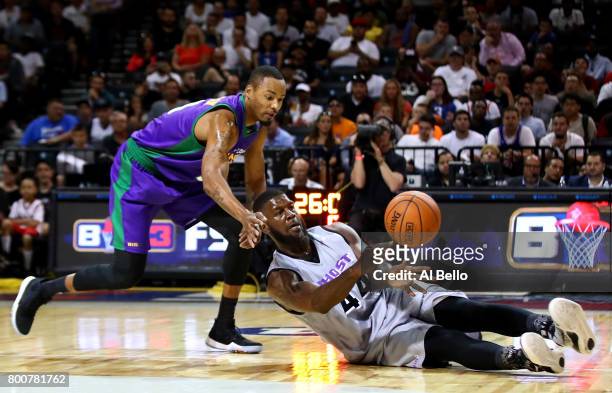 Ivan Johnson of the Ghost Ballers passes against Rashard Lewis of the 3 Headed Monsters during week one of the BIG3 three on three basketball league...