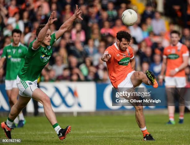 Armagh , Ireland - 25 June 2017; Jamie Clarke of Armagh scoring a point despite the attention of Che Cullen of Fermanagh during the GAA Football...