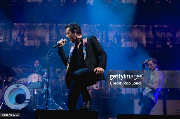 Ronnie Vannucci, Brandon Flowers, and Mark Stoermer of The Killers performs a surprise concert at Glastonbury Festival Site on June 25, 2017 in...