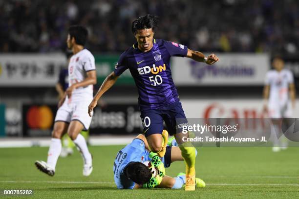 Masato Kudo of Sanfrecce Hiroshima and Kenya Matsui of Omiya Ardija compete for the ball during the J.League J1 match between Sanfrecce Hiroshima and...