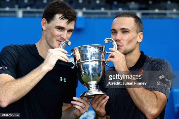Jamie Murray of Great Britain and partner Bruno Soares of Brazil celebrate victory with the trophy following the mens doubles final against Julien...