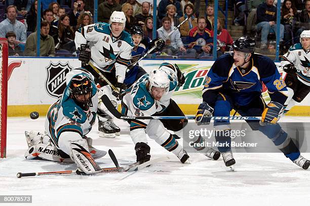 Brad Boyes of the St. Louis Blues tries to shoot the puck past Brian Campbell of the San Jose Sharks and Brian Boucher of the San Jose Sharks on...