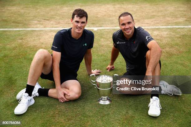 Jamie Murray of Great Britain and partner Bruno Soares of Brazil celebrate victory with the trophy following the mens doubles final against Julien...