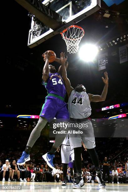 Kwame Brown of the 3 Headed Monsters drives to the basket against Ivan Johnson of the Ghost Ballers during week one of the BIG3 three on three...