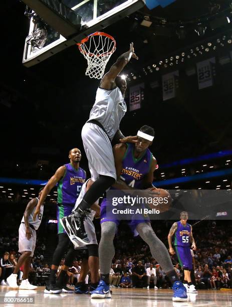 Kwame Brown of the 3 Headed Monsters handles the ball against Ivan Johnson of the Ghost Ballers during week one of the BIG3 three on three basketball...