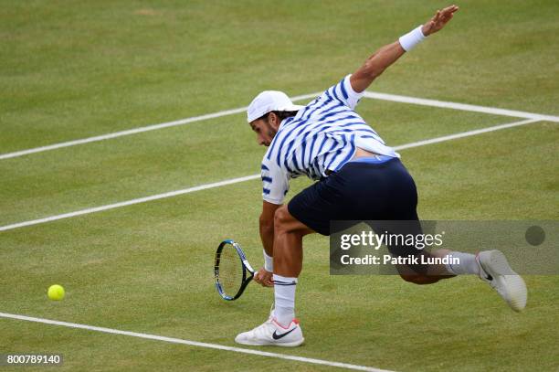 Feliciano Lopez of Spain reach for a backhand during the Final match against Marin Cilic of Croatia on day seven at Queens Club on June 25, 2017 in...