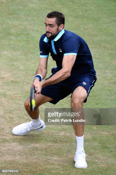 Marin Cilic of Croatia hits a backhand during the Final match against Feliciano Lopes of Spain on day seven at Queens Club on June 25, 2017 in...