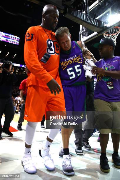 Jason Williams of the 3 Headed Monsters is helped off the floor after an injury in the game against the Ghost Ballers during week one of the BIG3...