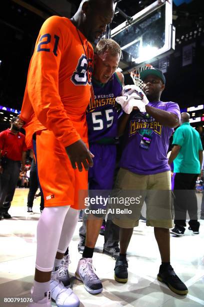 Jason Williams of the 3 Headed Monsters is helped off the floor after an injury in the game against the Ghost Ballers during week one of the BIG3...