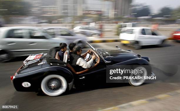 Indian motor enthusiast Ranjit Malik drives his 1960's Triumph vintage car after the flag off of ' the 42nd Statesman Vintage & Classic Car Rally...