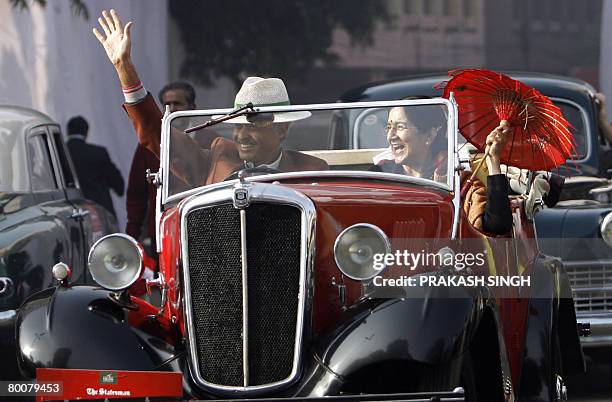 Dr. Vijay Chandra waves as he drives his 1937 Morris 8 vintage car as his companion looks on after the flag off of 'the 42nd Statesman Vintage &...