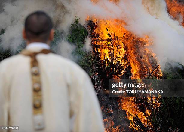 Buddhist monk prays in front of a fire during the traditional "hi-watari", or fire-walking ritual, which heralds the coming of spring, at the...