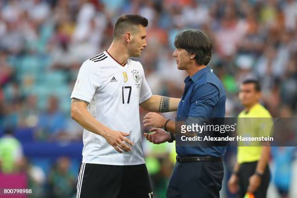 Niklas Suele of Germany talks to head coach Joachim Loew during the FIFA Confederations Cup Russia 2017 Group B match between Germany and Cameroon at...