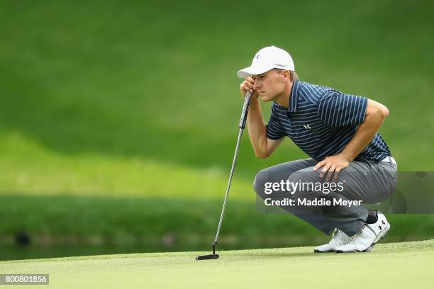 Jordan Spieth of the United States lines up a putt on the eighth green during the final round of the Travelers Championship at TPC River Highlands on...