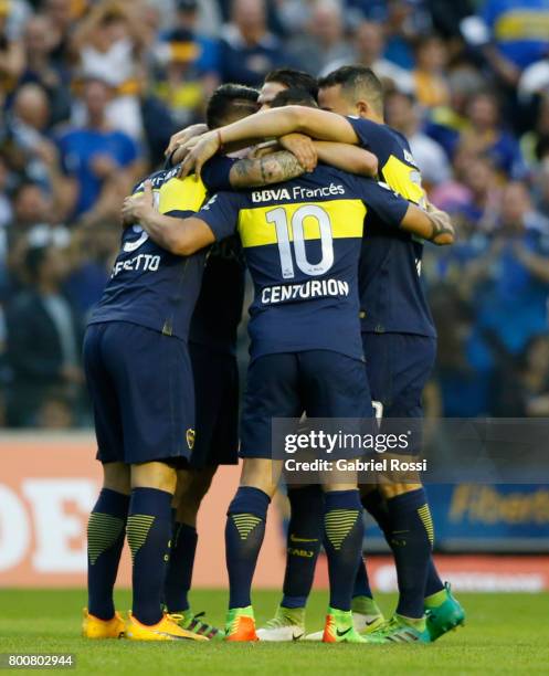 Dario Benedetto of Boca Juniors celebrates with teammates Cristian Pavon and Ricardo Centurion after scoring the second goal of his team during a...