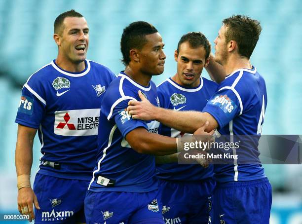 Michael Sullivan of the Bulldogs celebrates with team mates after scoring a try during the NRL trial match between the Bulldogs and the Penrith...