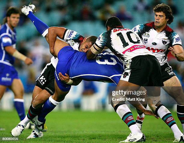 Lee Te Maari of the Bulldogs is tackled heavily by Michael Jennings of the Panthers during the NRL trial match between the Bulldogs and the Penrith...
