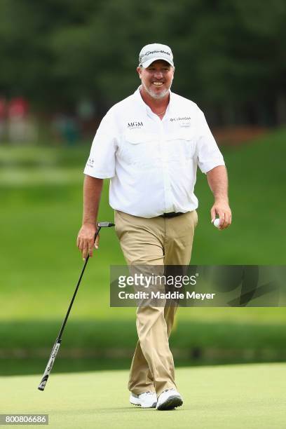 Boo Weekley of the United States reacts after putting on the eighth green during the final round of the Travelers Championship at TPC River Highlands...