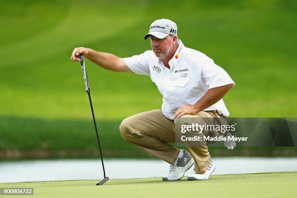 Boo Weekley of the United States lines up a putt on the eighth green during the final round of the Travelers Championship at TPC River Highlands on...